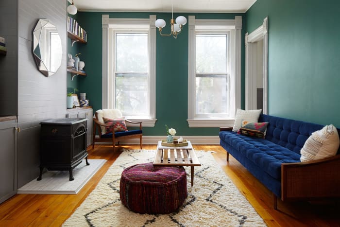 The bright blue sofa in this Boston apartment was scored used online. Photo by Dustin Halleck for Homepolish, Designed by Megan Bachmann