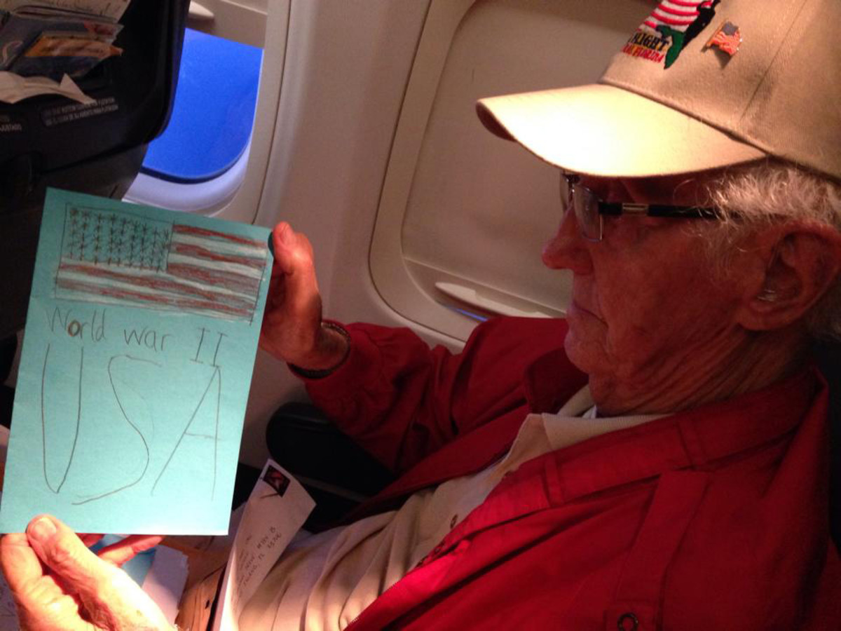 Bob reads a handmade card reminding him of his service during World War II.